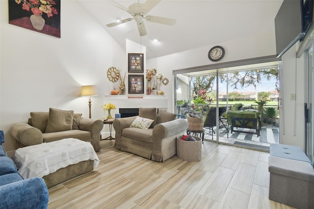 living room with light hardwood / wood-style floors, high vaulted ceiling, and ceiling fan