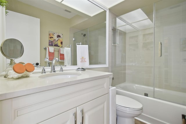 full bathroom with vanity, toilet, and enclosed tub / shower combo