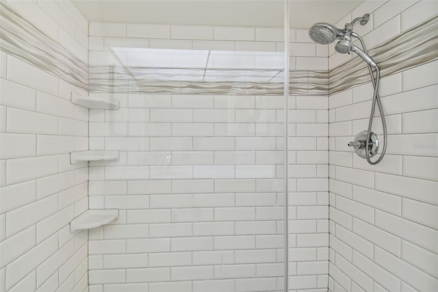 bathroom with tiled shower