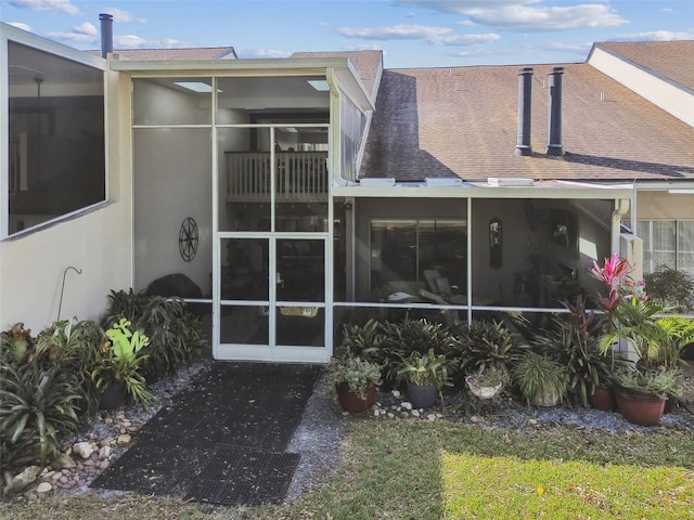 rear view of house featuring a sunroom