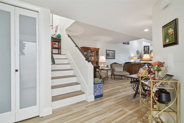 staircase with hardwood / wood-style flooring