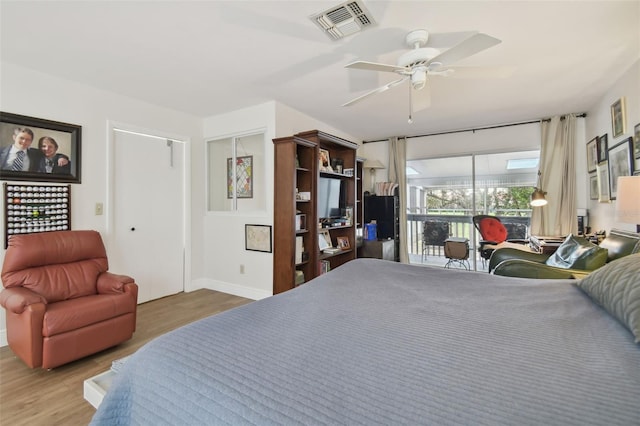 bedroom featuring access to outside, ceiling fan, and hardwood / wood-style floors