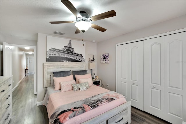 bedroom with ceiling fan, a closet, and dark hardwood / wood-style floors