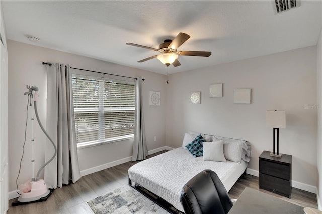 bedroom featuring hardwood / wood-style floors and ceiling fan