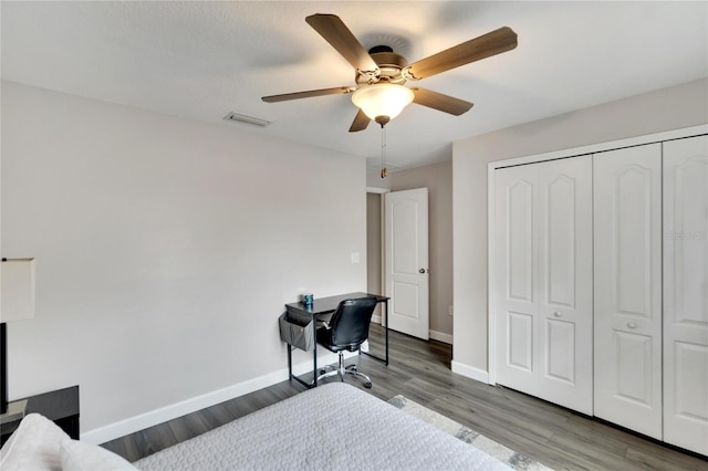 bedroom with ceiling fan, a closet, and wood-type flooring