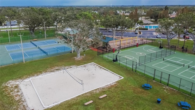 view of sport court featuring a lawn