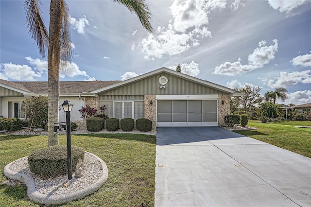 ranch-style home with a garage and a front lawn