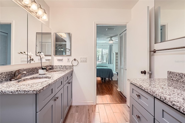 bathroom featuring vanity, hardwood / wood-style flooring, and ceiling fan