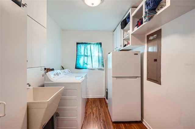 laundry room with hardwood / wood-style floors, washing machine and dryer, sink, and electric panel