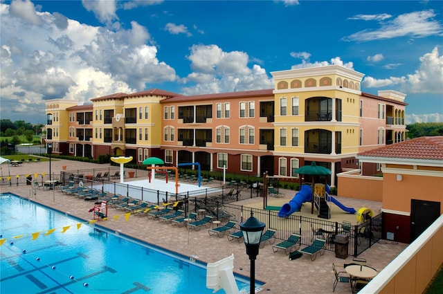 view of pool with a playground