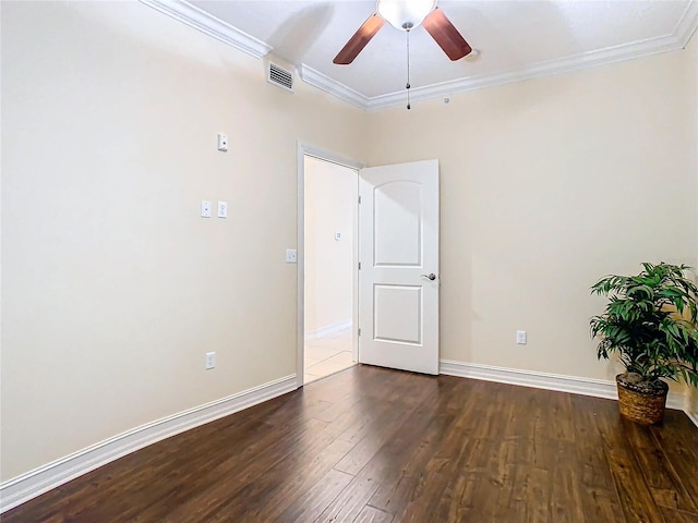 empty room featuring dark hardwood / wood-style flooring, ceiling fan, and crown molding