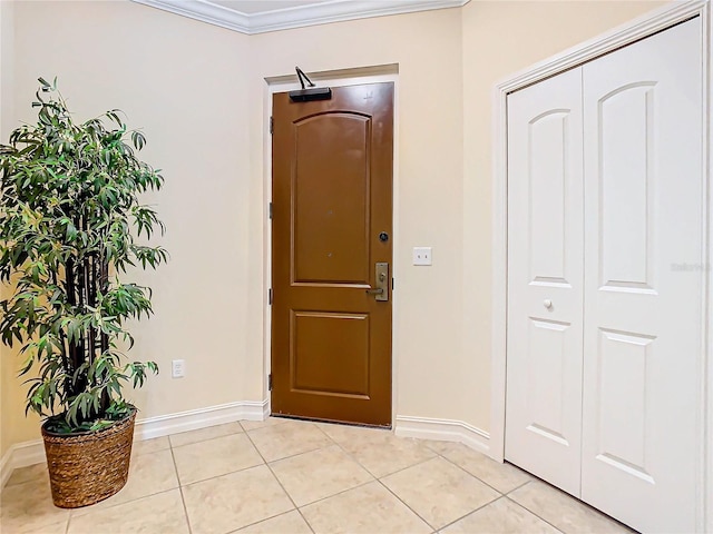 tiled foyer entrance with crown molding