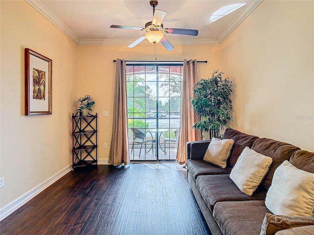 living room with ornamental molding, dark wood-type flooring, and ceiling fan