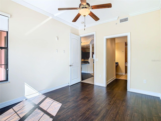 spare room featuring dark wood-type flooring, ceiling fan, and crown molding