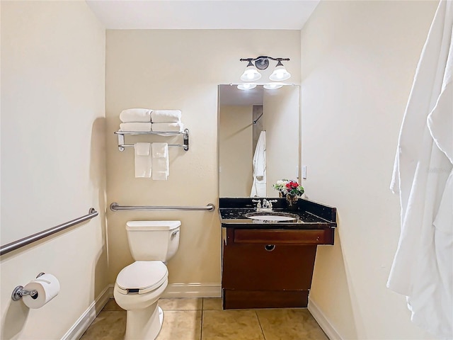 bathroom featuring vanity, tile patterned floors, and toilet