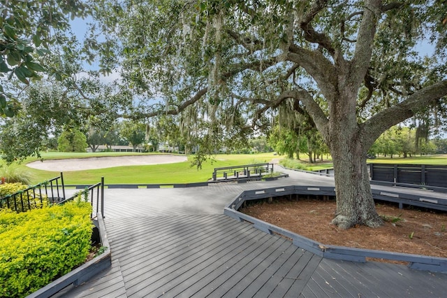 view of community featuring a deck and a yard