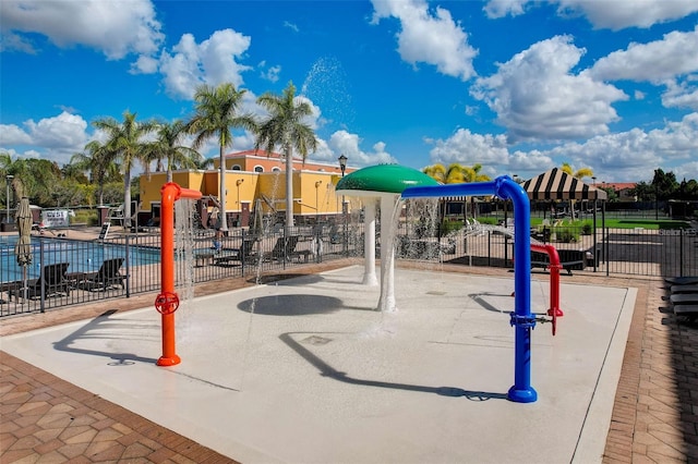 view of playground with a community pool and a patio area