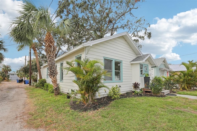 view of home's exterior with a lawn