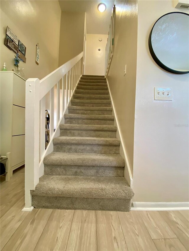 stairway featuring hardwood / wood-style flooring