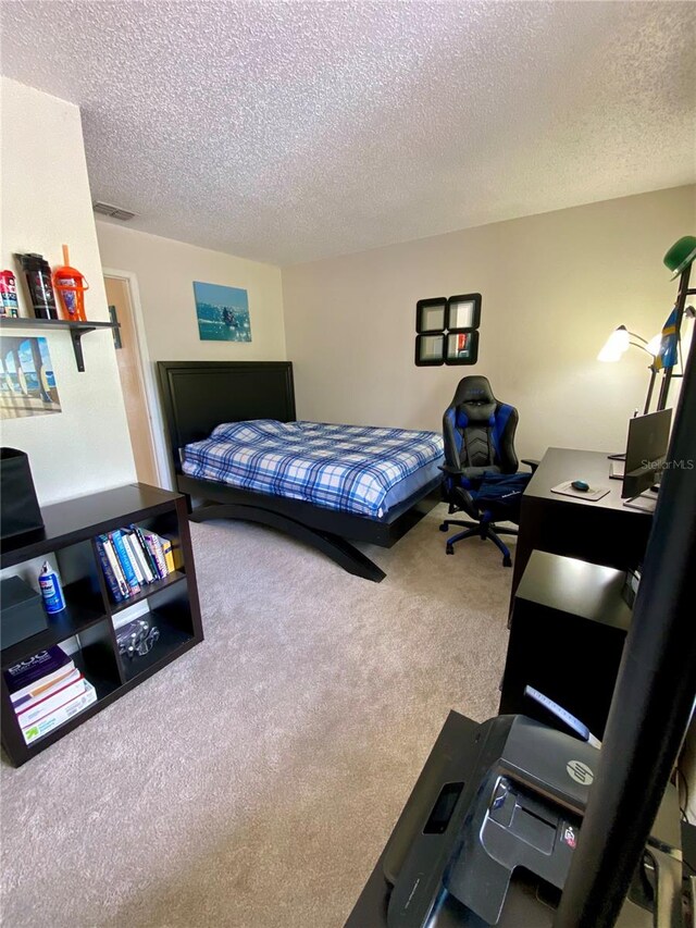 carpeted bedroom with a textured ceiling