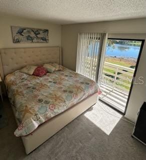 carpeted bedroom with a textured ceiling