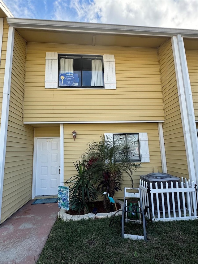 rear view of house with central AC unit