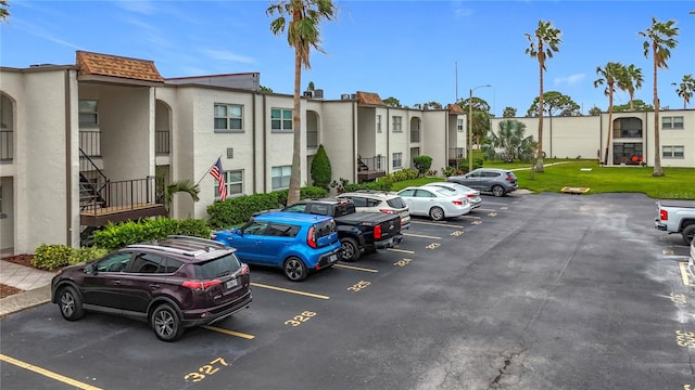 view of parking / parking lot with a yard