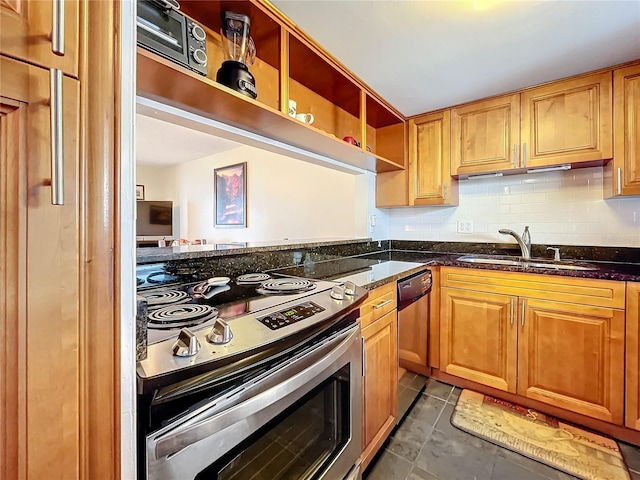 kitchen featuring backsplash, appliances with stainless steel finishes, dark tile patterned flooring, sink, and dark stone countertops