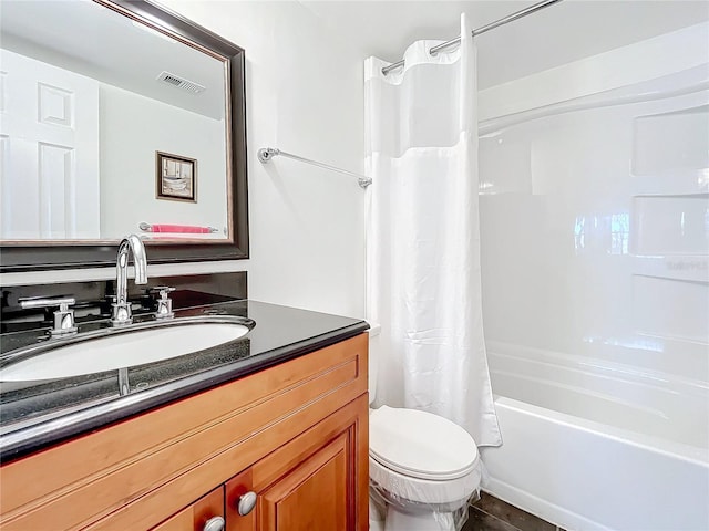 full bathroom with shower / bath combo, vanity, and toilet