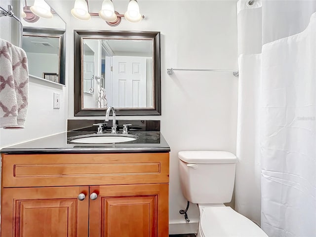 bathroom featuring toilet and vanity