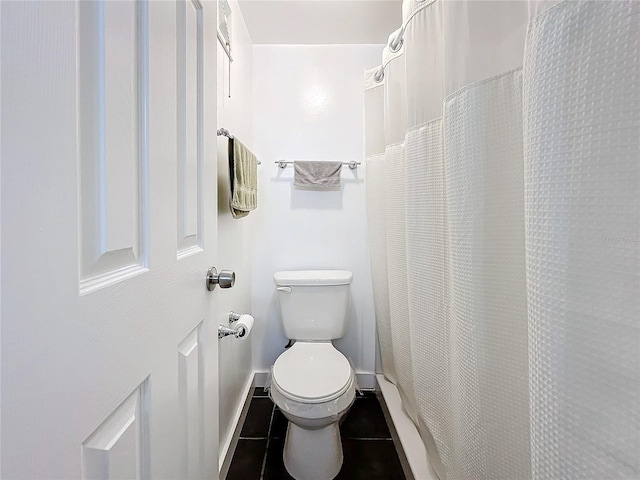 bathroom with toilet and tile patterned floors