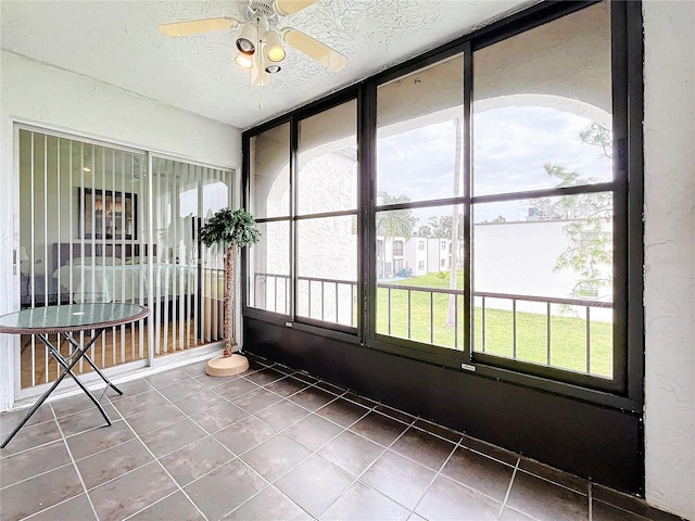 unfurnished sunroom with a wealth of natural light and ceiling fan