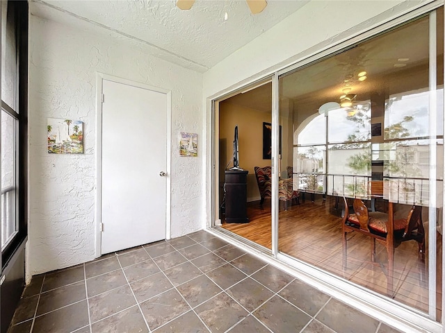 sunroom featuring ceiling fan