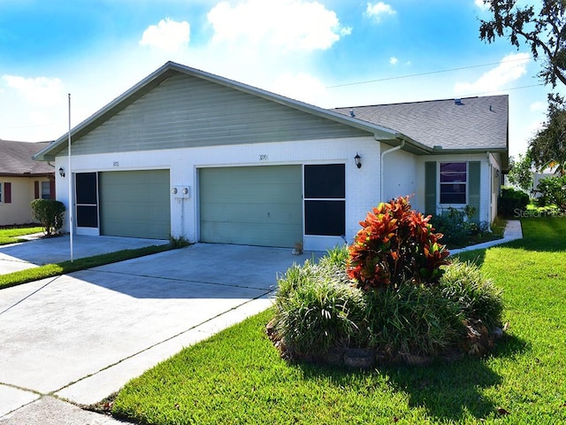 ranch-style house featuring a garage and a front lawn