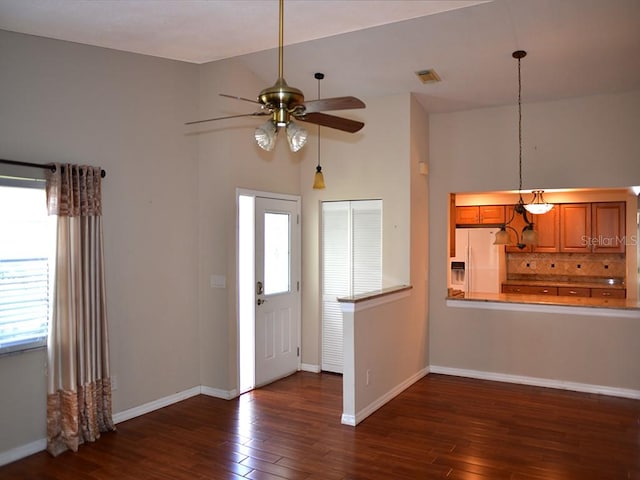 foyer featuring dark hardwood / wood-style flooring, ceiling fan, and vaulted ceiling