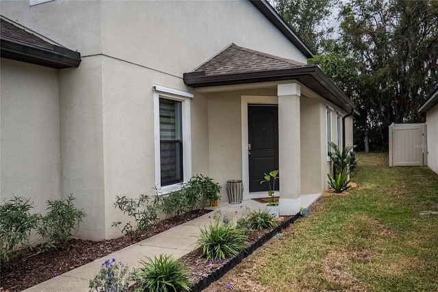 view of exterior entry with a yard