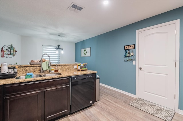 kitchen featuring hanging light fixtures, sink, light hardwood / wood-style flooring, and dishwasher