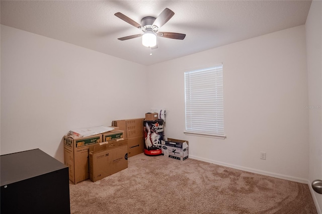 misc room featuring a textured ceiling, light colored carpet, and ceiling fan