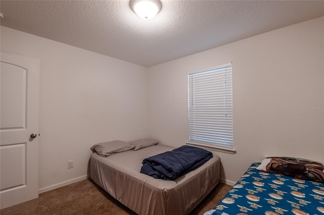 carpeted bedroom featuring a textured ceiling