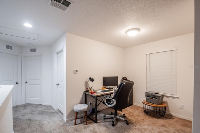 home office with a textured ceiling and light carpet