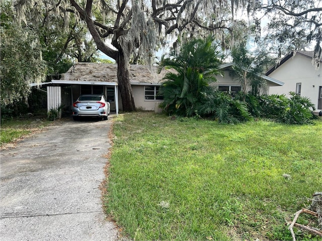 ranch-style house with a front yard and a carport