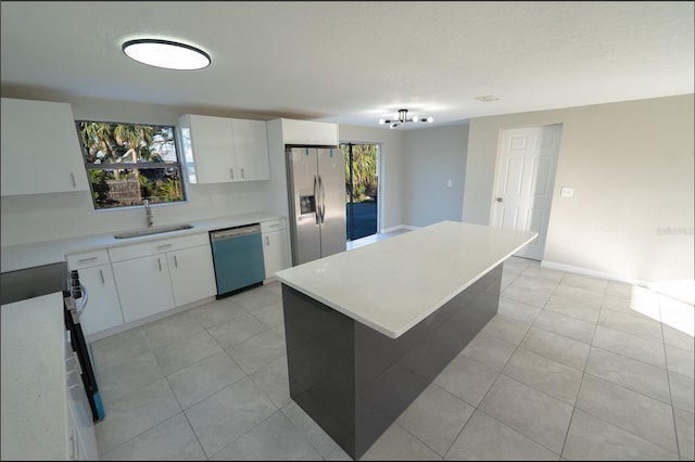 kitchen with stainless steel appliances, white cabinetry, and plenty of natural light