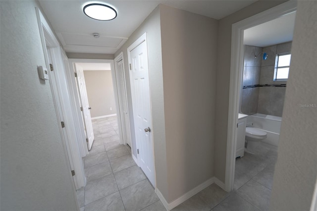 corridor with light tile patterned flooring