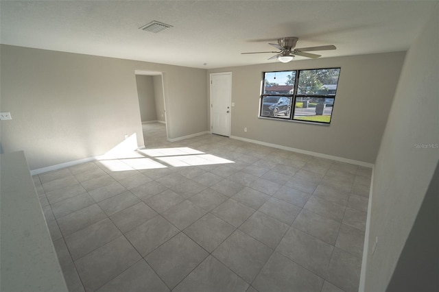 unfurnished room with light tile patterned floors and ceiling fan