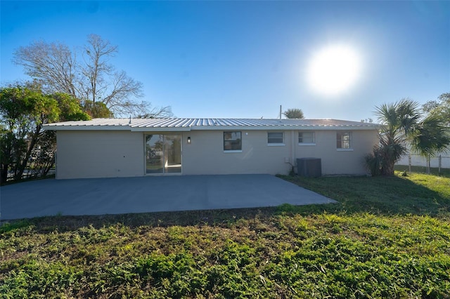 rear view of house featuring a yard and a patio