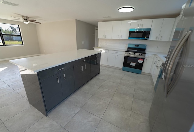 kitchen with white cabinetry, a center island, ceiling fan, and stainless steel appliances