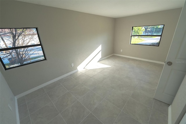 tiled spare room with a wealth of natural light