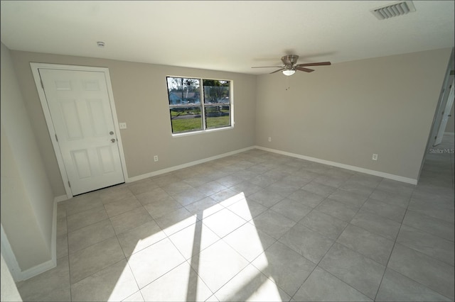 tiled spare room with ceiling fan