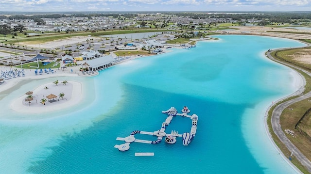 bird's eye view featuring a water view and a beach view