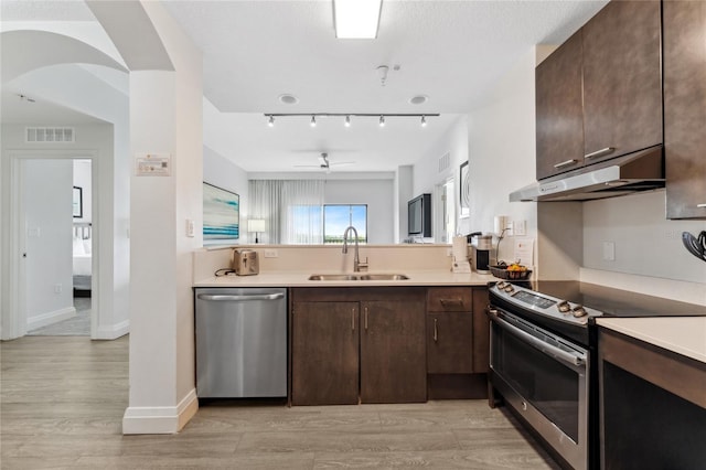 kitchen featuring sink, dark brown cabinets, light hardwood / wood-style floors, and stainless steel appliances